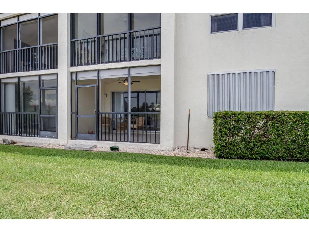 49 High Point Circle South, Unit 102 Naples, FL 34103 - Photo 25 of 31 a view of front door of a house with a yard