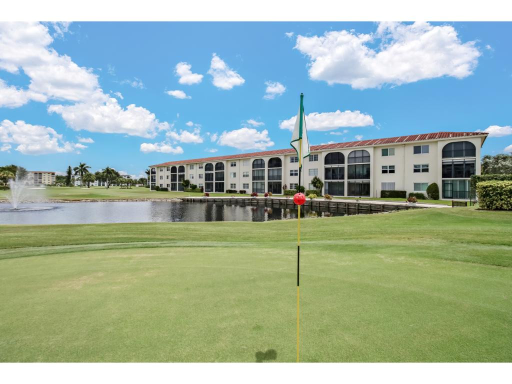 49 High Point Circle South, Unit 102 Naples, FL 34103 - Photo 26 of 31 a view of a house with a big yard