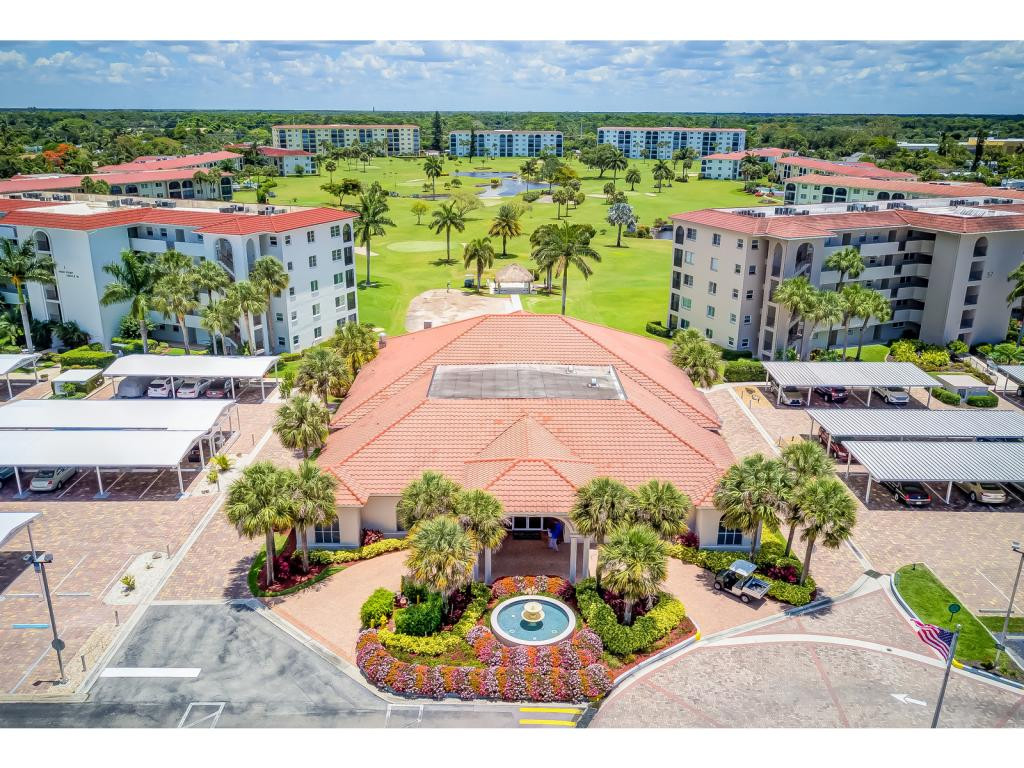 49 High Point Circle South, Unit 102 Naples, FL 34103 - Photo 28 of 31 a view of a patio with table and chairs potted plants