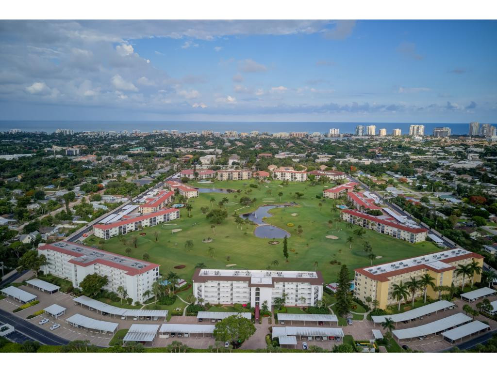 49 High Point Circle South, Unit 102 Naples, FL 34103 - Photo 29 of 31 an aerial view of residential houses with outdoor space and trees
