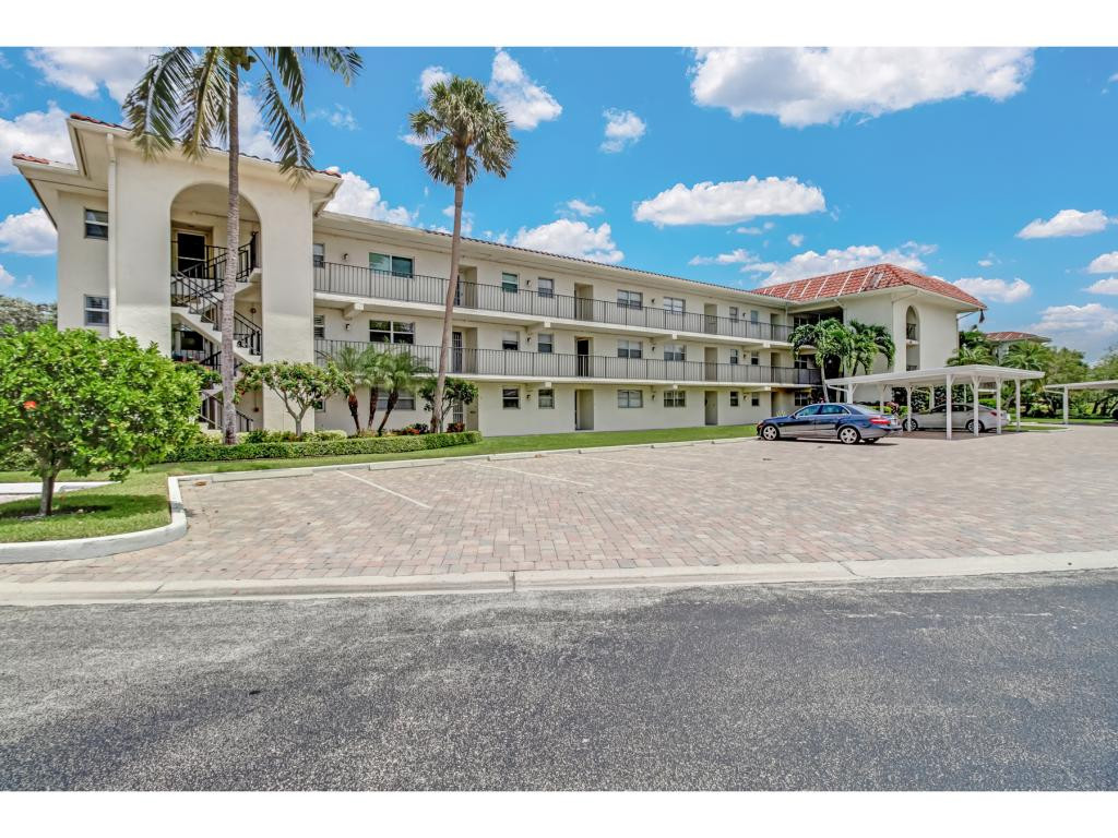 49 High Point Circle South, Unit 102 Naples, FL 34103 - Photo 5 of 31 a view of building with outdoor space and street view
