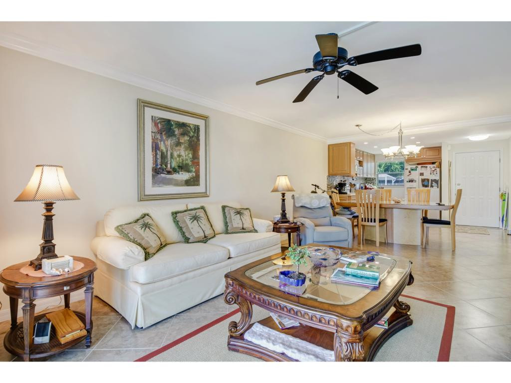 49 High Point Circle South, Unit 102 Naples, FL 34103 - Photo 8 of 31 a living room with furniture and a table