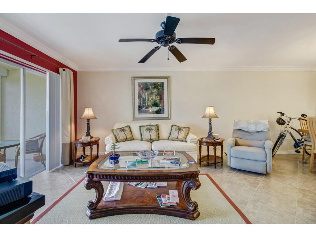 49 High Point Circle South, Unit 102 Naples, FL 34103 - Photo 10 of 31 a living room with furniture and a wooden floor