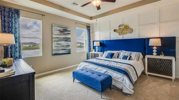 a spacious bedroom with a bed and a window