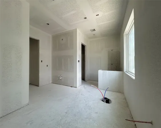 an empty room with windows and cabinet