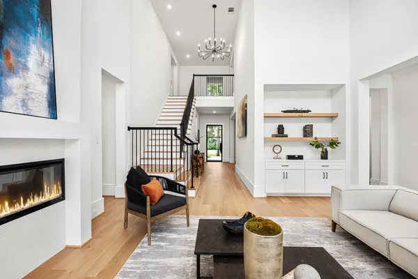 a living room with furniture a fireplace and a large mirror