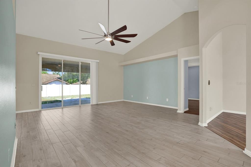 4400 Dior Road Spring Hill, FL 34609 - Photo 9 of 37 a view of an empty room with wooden floor and a window