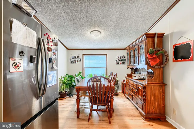 a view of a dining room with furniture carpet and wooden floor