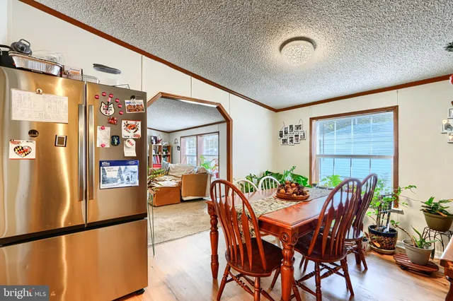 a view of a dining room with furniture and window