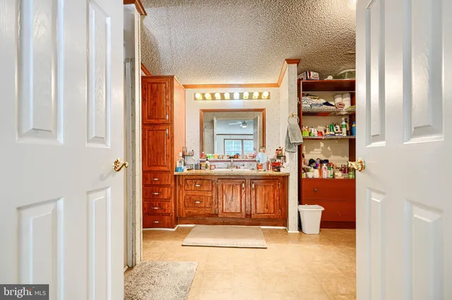 a living room with furniture a window and a dresser