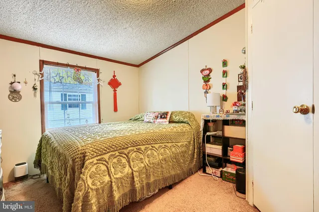 a bed sitting in a bedroom next to a window