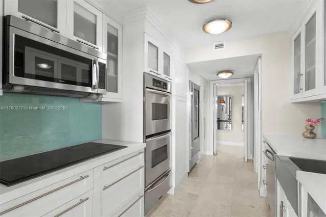 a kitchen with granite countertop stainless steel appliances and cabinets