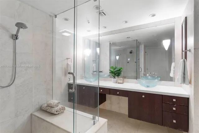a bathroom with a double vanity sink shower and a mirror