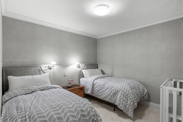 a bedroom with two beds and lamp