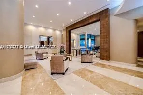 a living room with furniture and view of kitchen