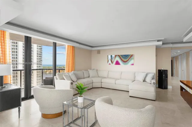 a living room with furniture and a large window