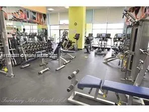 a room with gym equipment and a table