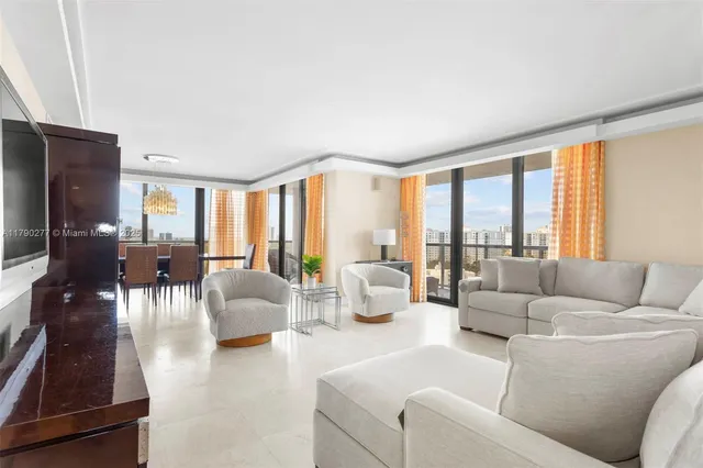 a living room with furniture and large windows