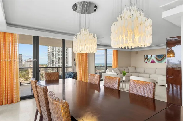 a living room with fireplace furniture and a large window