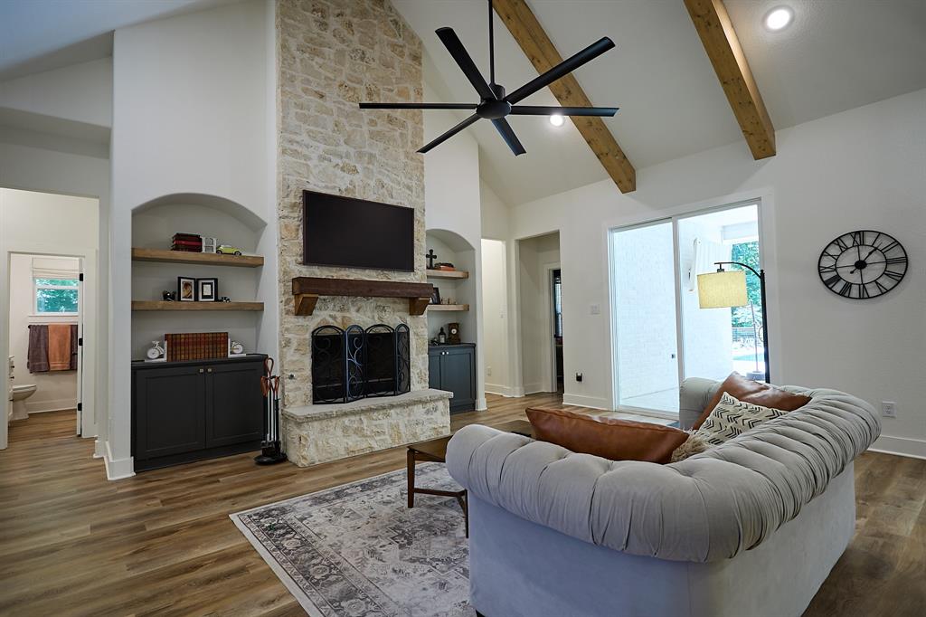 358 Glade Valley Road Azle, TX 76020 - Photo 5 of 35 Spacious living area featuring a vaulted ceiling with exposed wood beams and a large ceiling fan