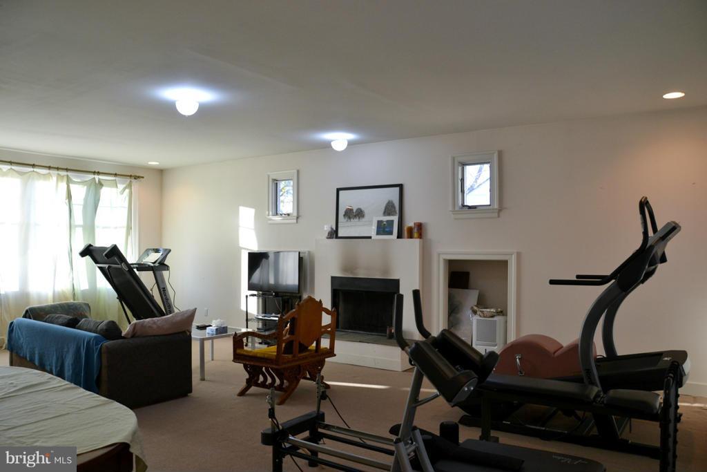 11613 Dewey Road Silver Spring, MD 20906 - Photo 5 of 15 a living room with furniture and a fireplace