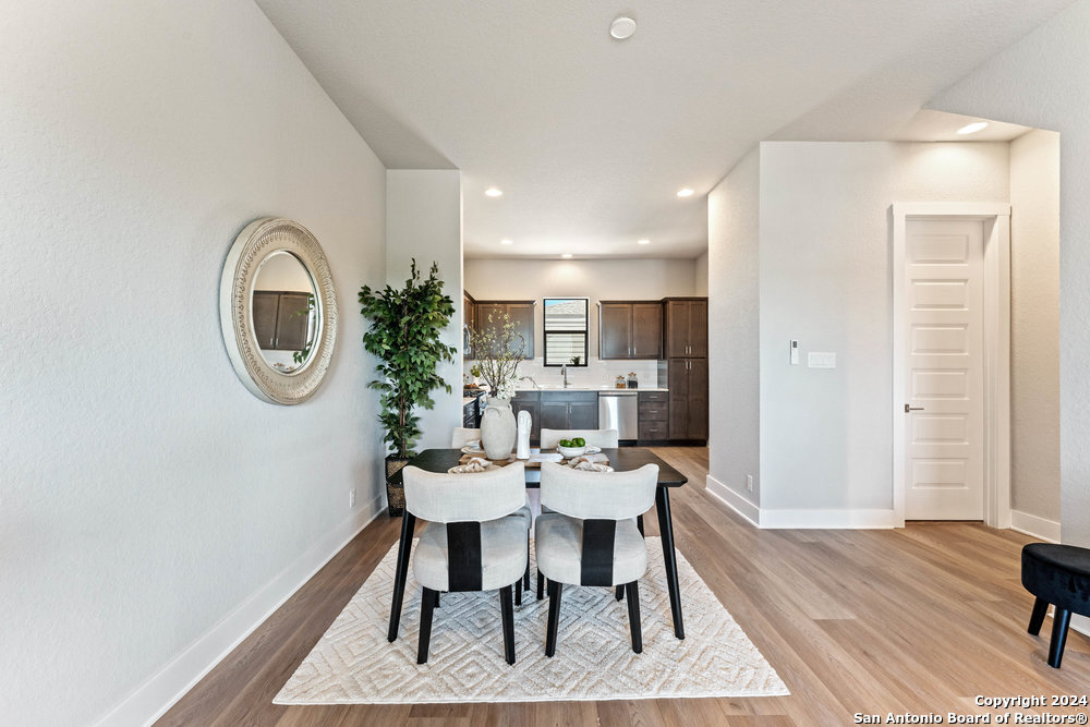 7942 Kennedy Hill Drive, Unit 8 San Antonio, TX 78235 - Photo 11 of 35 a view of a dining room with furniture and wooden floor