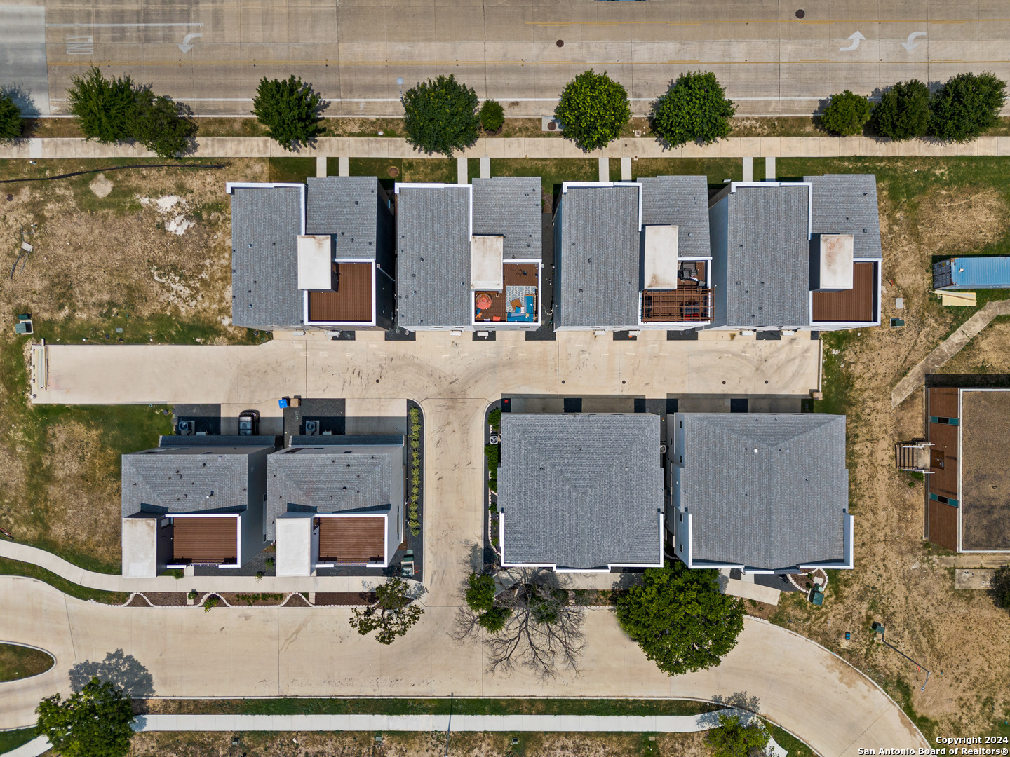 7942 Kennedy Hill Drive, Unit 8 San Antonio, TX 78235 - Photo 33 of 35 an aerial view of residential houses with outdoor space and parking