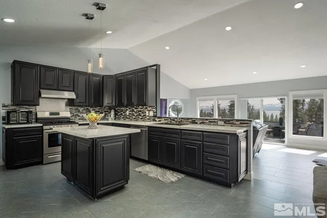 a kitchen with kitchen island granite countertop a sink and stove