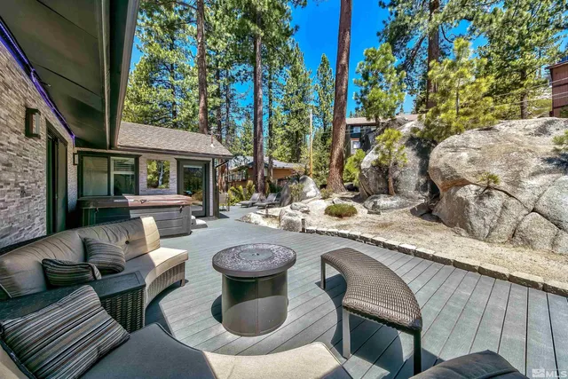 a view of a patio with couches table and chairs and potted plants