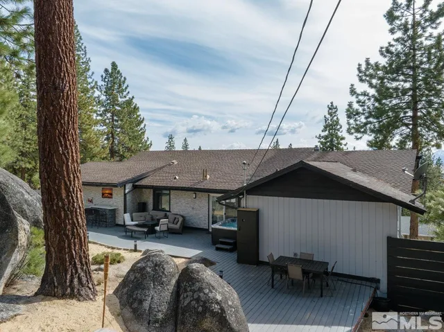 a view of house with backyard outdoor seating and mountain view
