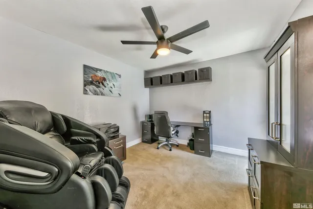 a view of a livingroom with workspace and a window