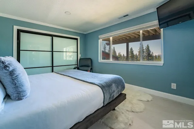 a bedroom with a bed and window