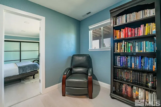 a living room with furniture and a book shelf