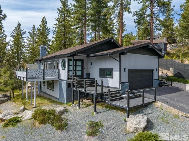 a view of house with backyard outdoor seating and trees