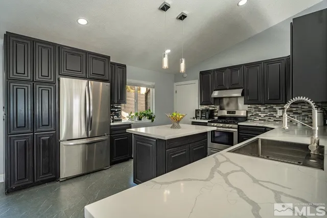 a kitchen with kitchen island granite countertop stainless steel appliances and wooden cabinets