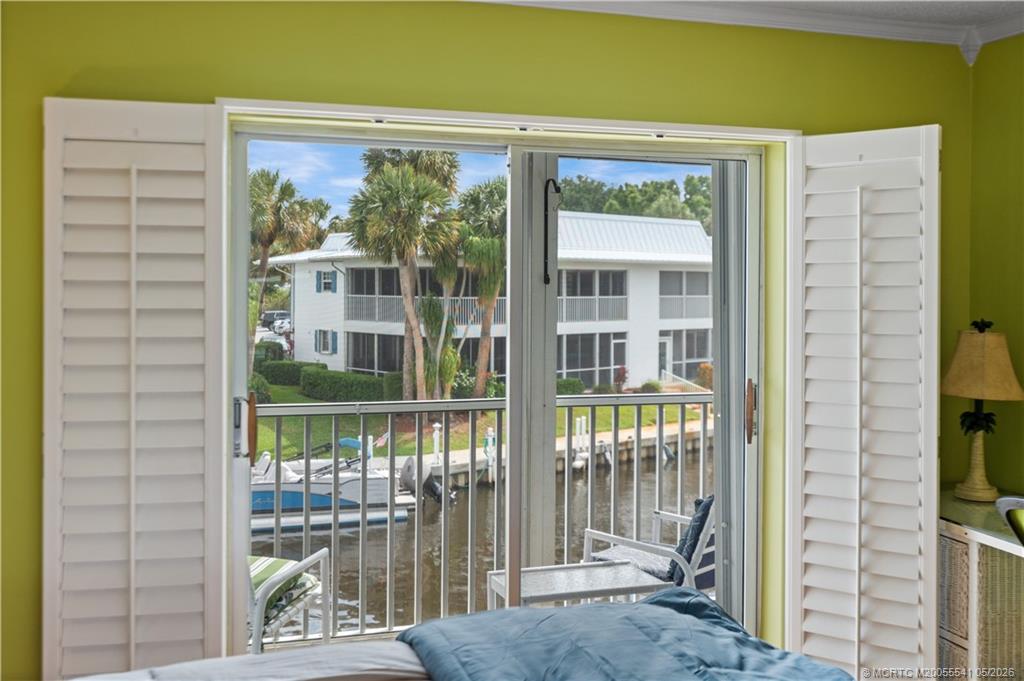 1866 Southwest Palm City Road, Unit 204 Stuart, FL 34994 - Photo 20 of 38 a view of a glass door with a tree