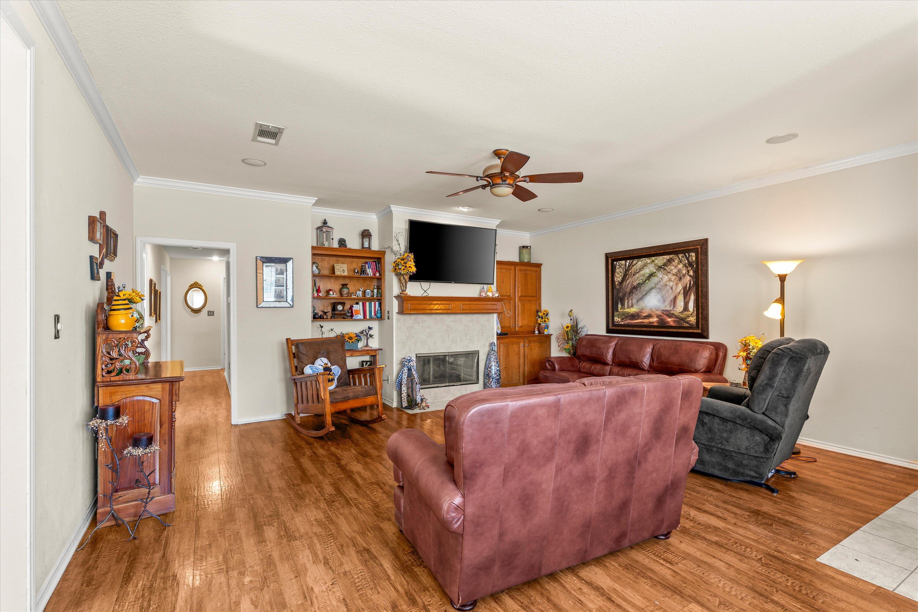 710 Poplar Street Levelland, TX 79336 - Photo 3 of 23 a living room with furniture and a fireplace