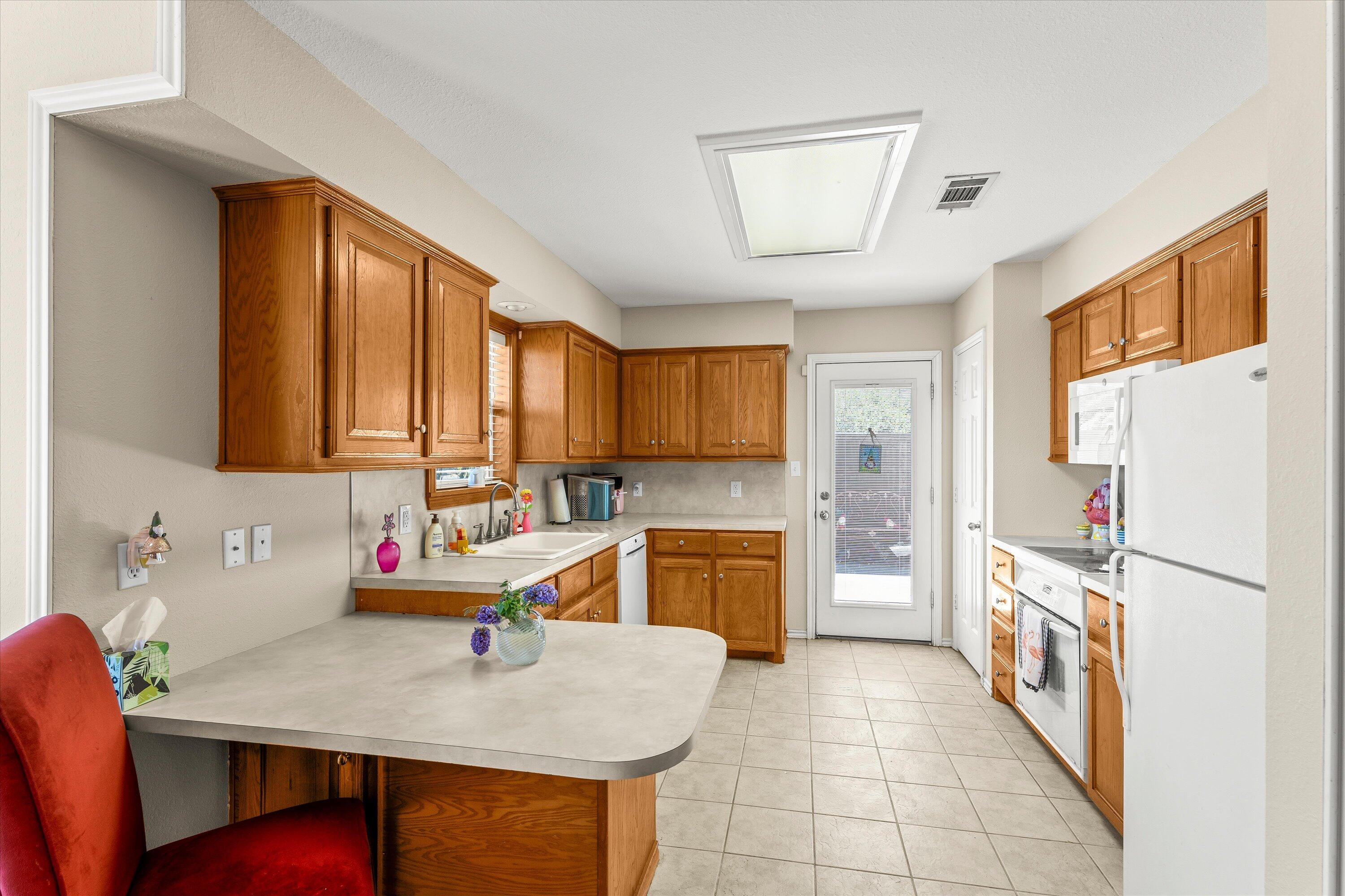 710 Poplar Street Levelland, TX 79336 - Photo 6 of 23 a kitchen with a sink stove and refrigerator