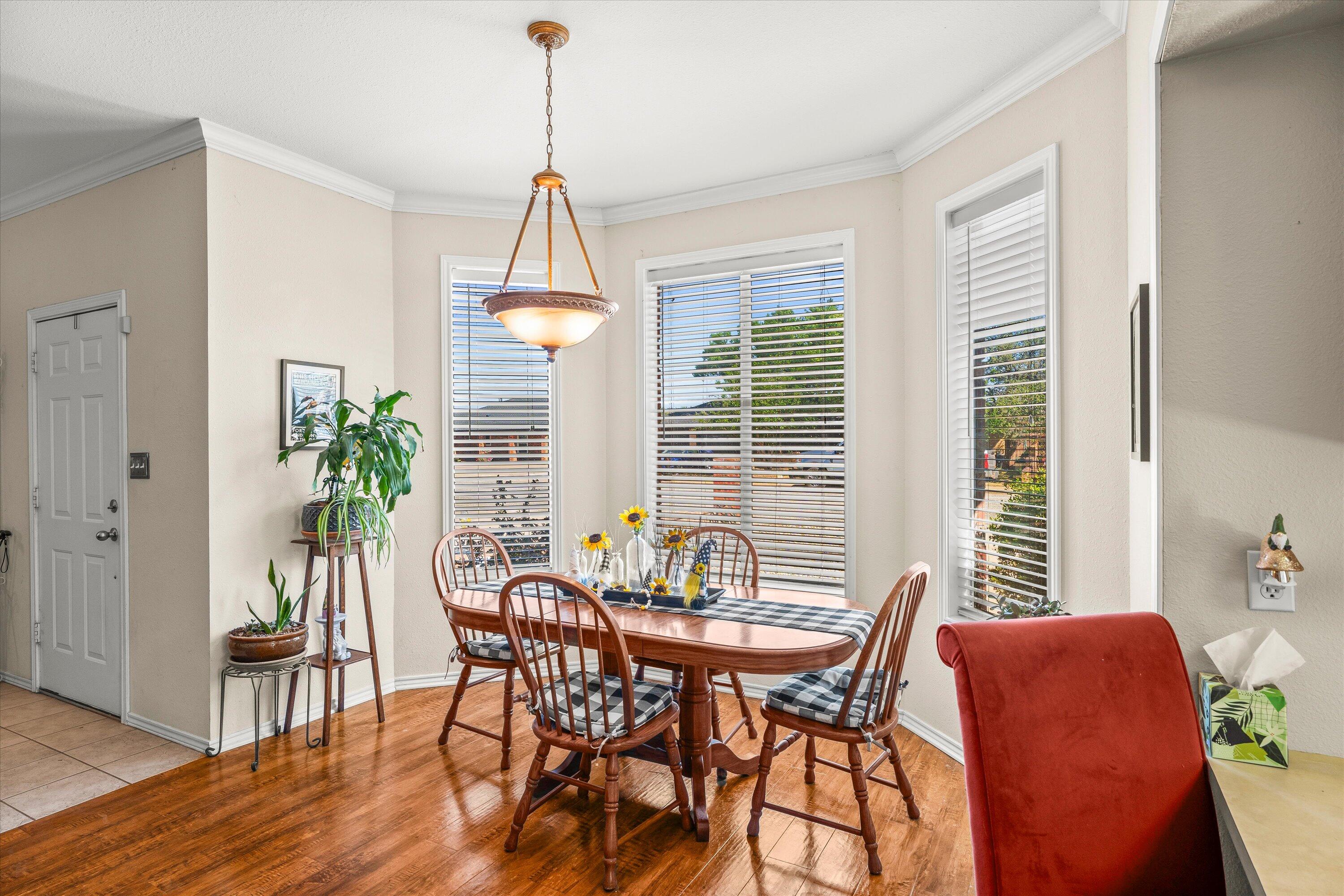 710 Poplar Street Levelland, TX 79336 - Photo 8 of 23 a dining room with furniture window and wooden floor