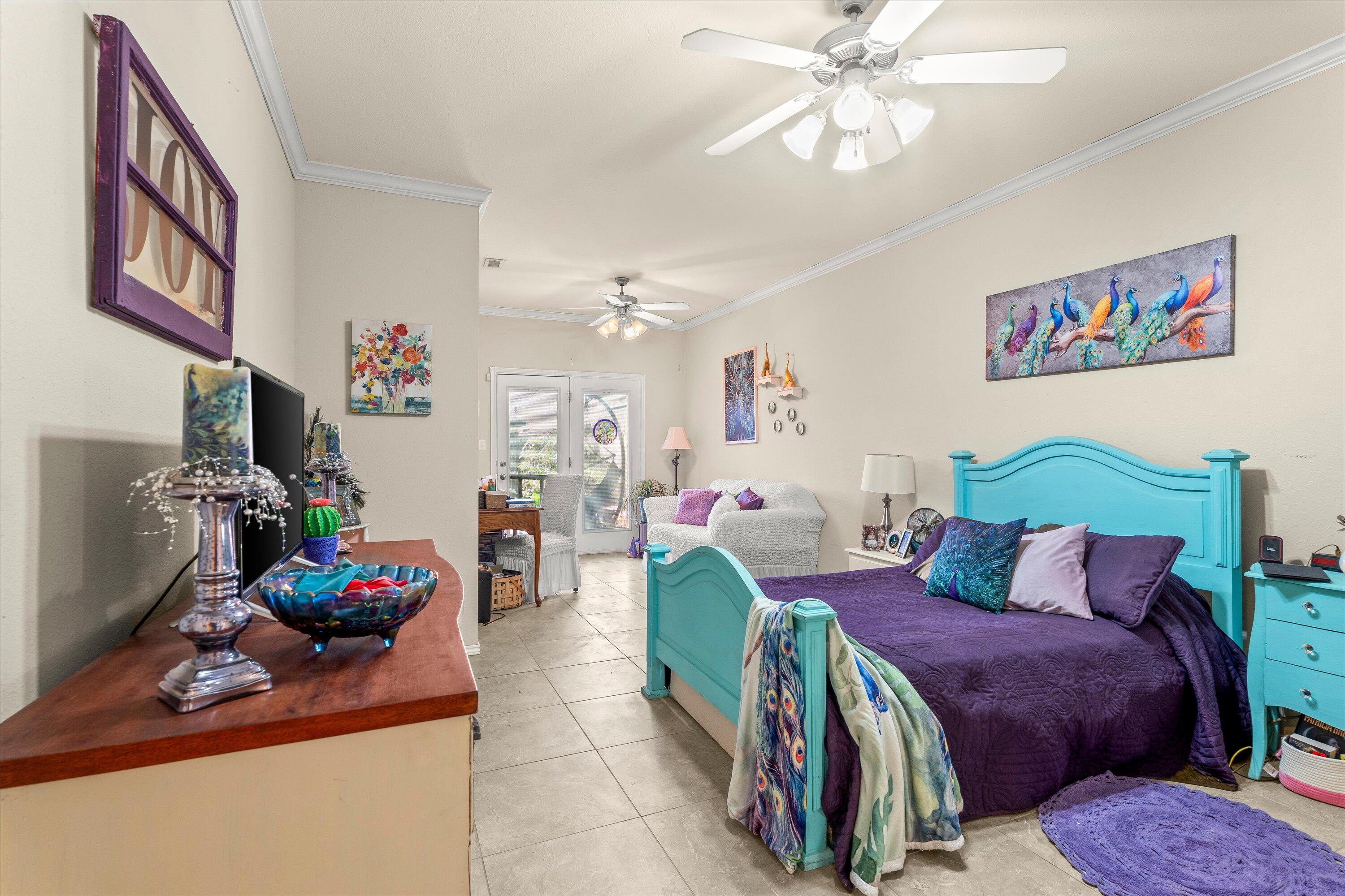 710 Poplar Street Levelland, TX 79336 - Photo 9 of 23 a bedroom with a bed and a chandelier