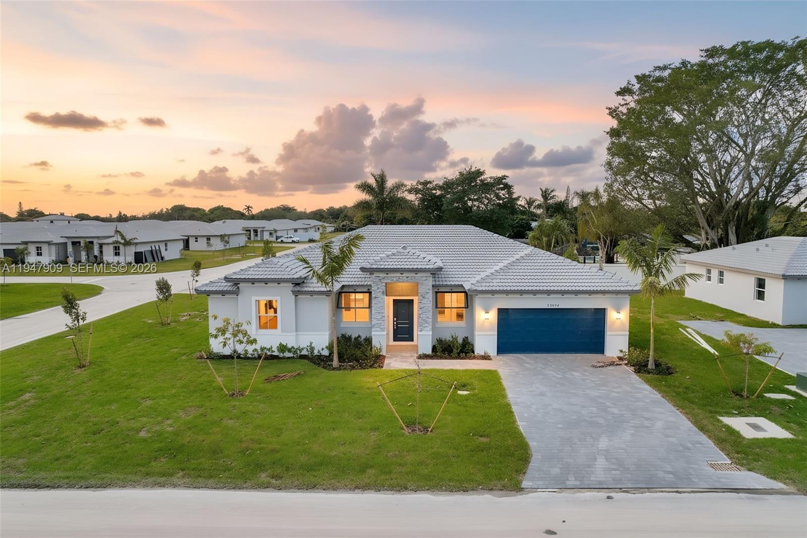 27254 Southwest 159th Path Homestead, FL 33031 - Photo 1 of 100 a front view of a house with a garden and lake view