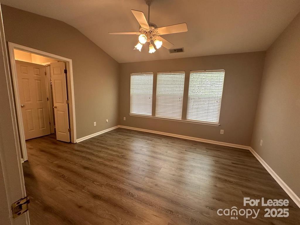 6828 Rothchild Drive Charlotte, NC 28270 - Photo 16 of 29 an empty room with wooden floor and windows