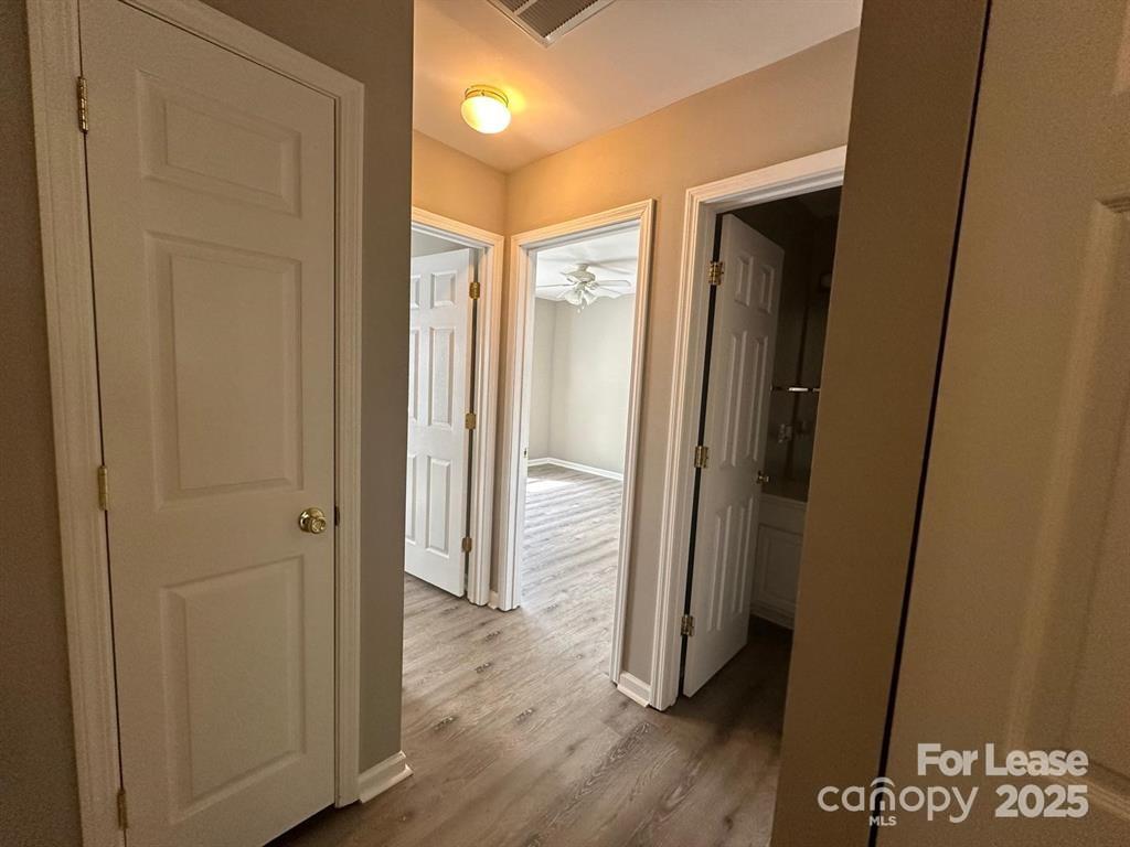 6828 Rothchild Drive Charlotte, NC 28270 - Photo 18 of 29 a view of a hallway with wooden floor
