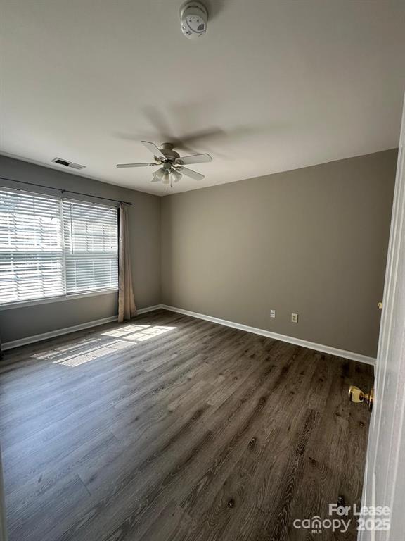 6828 Rothchild Drive Charlotte, NC 28270 - Photo 19 of 29 an empty room with wooden floor and windows