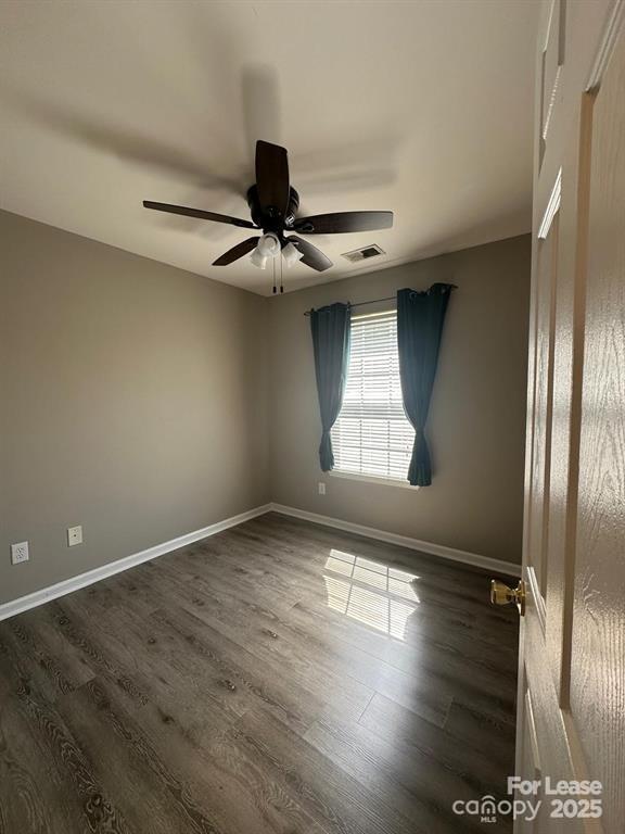 6828 Rothchild Drive Charlotte, NC 28270 - Photo 20 of 29 an empty room with wooden floor and windows