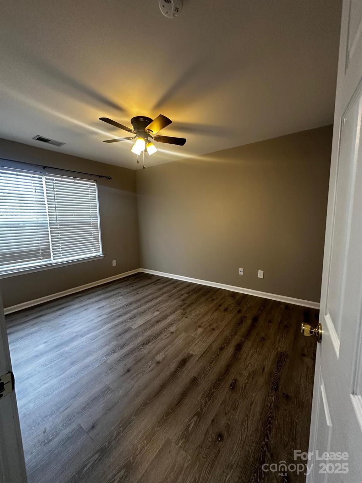 6828 Rothchild Drive Charlotte, NC 28270 - Photo 22 of 29 wooden floor in an empty room with a window