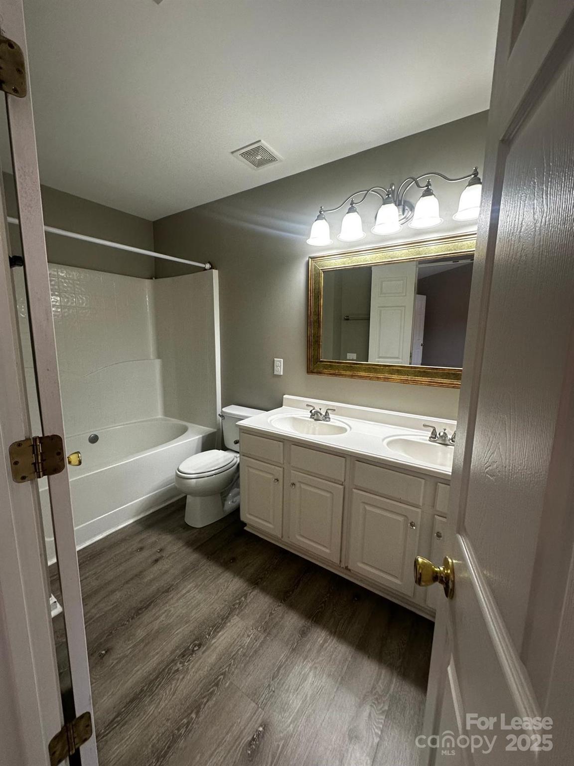 6828 Rothchild Drive Charlotte, NC 28270 - Photo 25 of 29 a bathroom with a double vanity sink toilet and mirror