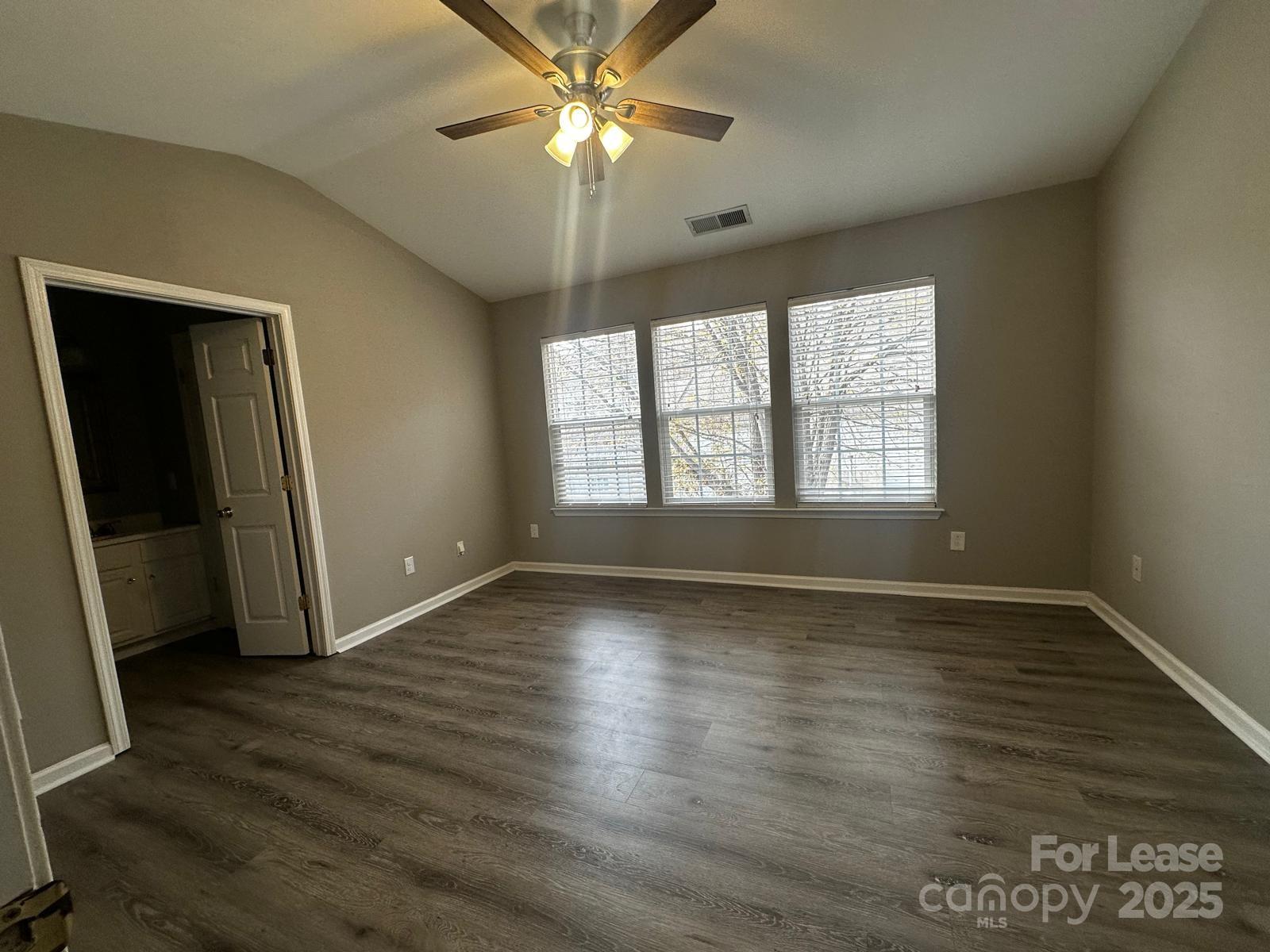 6828 Rothchild Drive Charlotte, NC 28270 - Photo 27 of 29 a view of an empty room with wooden floor and a window