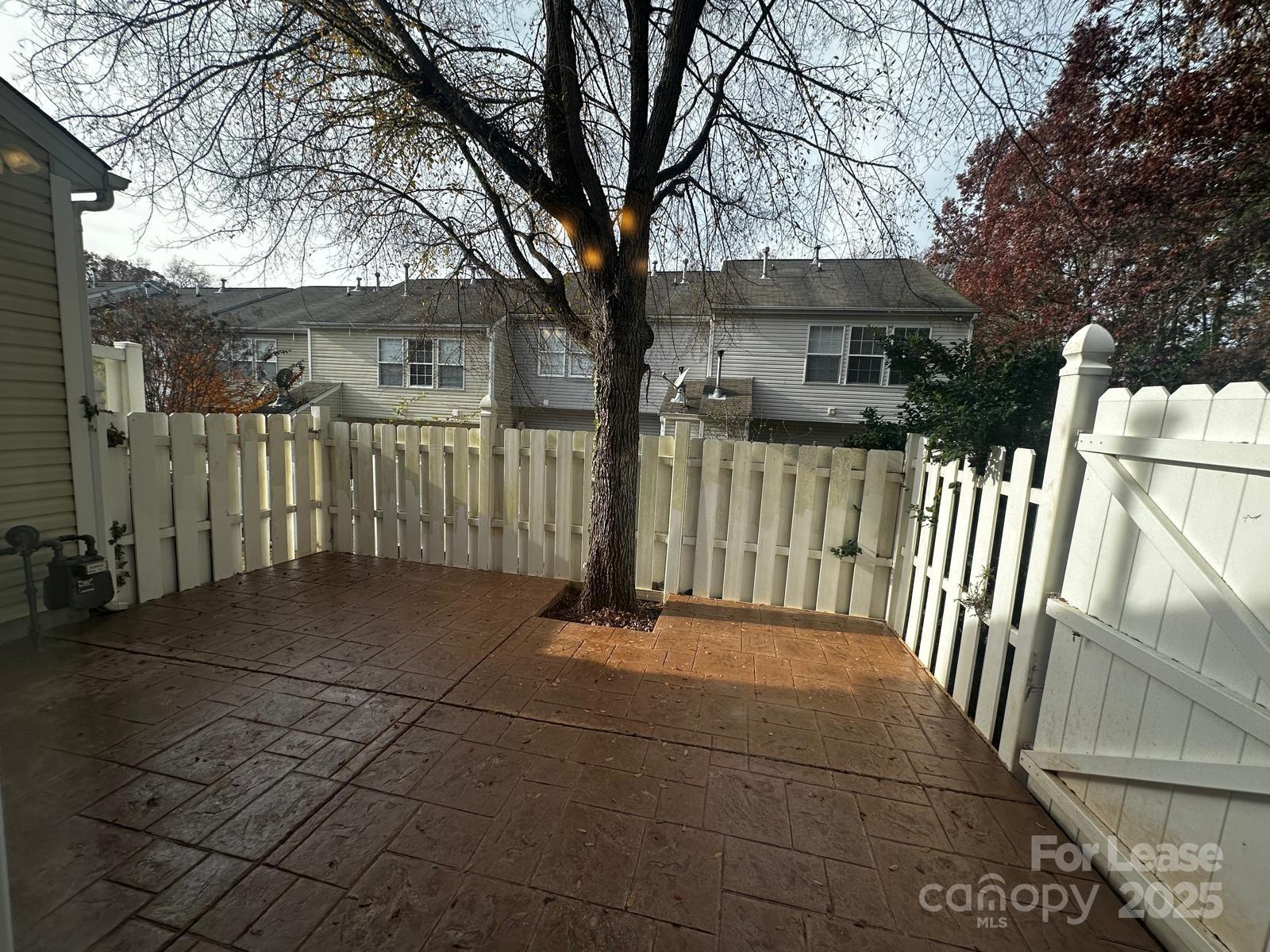 6828 Rothchild Drive Charlotte, NC 28270 - Photo 29 of 29 a view of a house with a small yard and a large tree