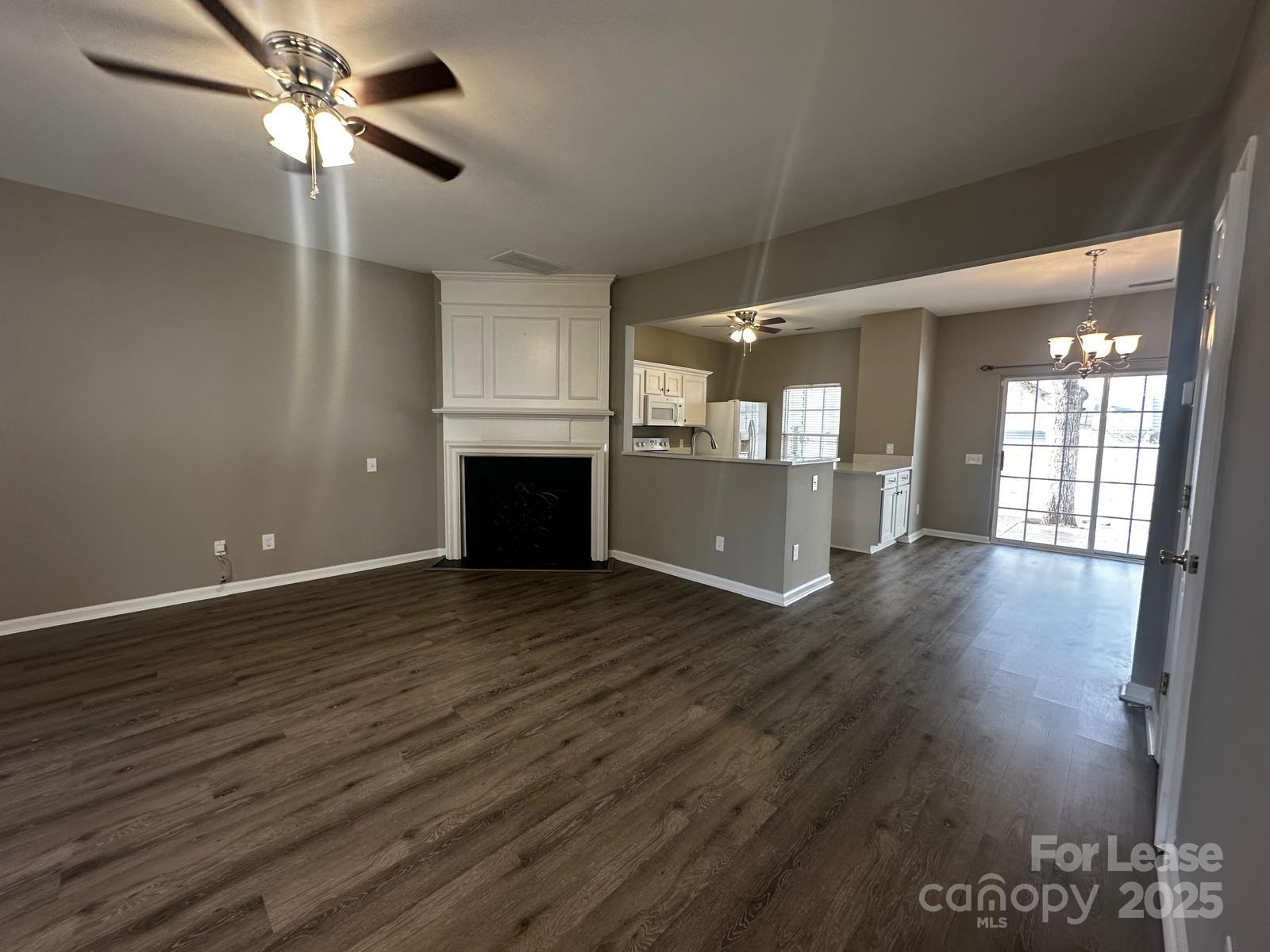 6828 Rothchild Drive Charlotte, NC 28270 - Photo 6 of 29 a view of empty room with wooden floor and fan